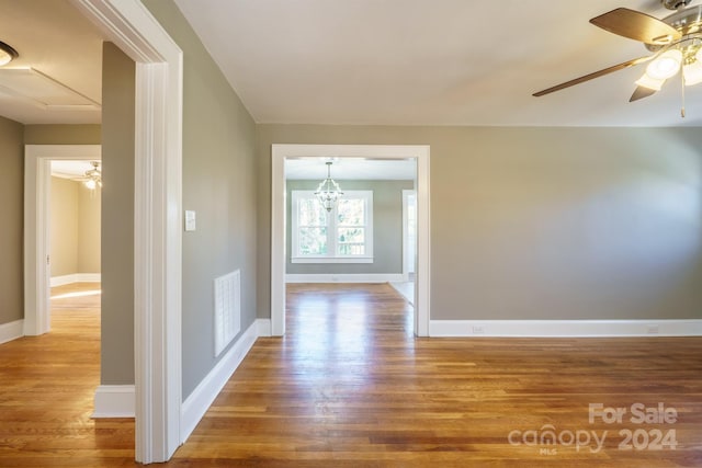 interior space with a notable chandelier and hardwood / wood-style flooring