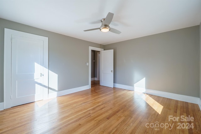 empty room featuring ceiling fan and light hardwood / wood-style flooring