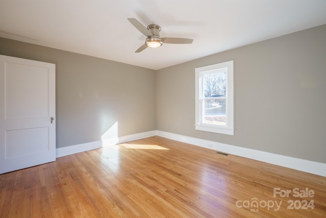 spare room with ceiling fan and light hardwood / wood-style flooring