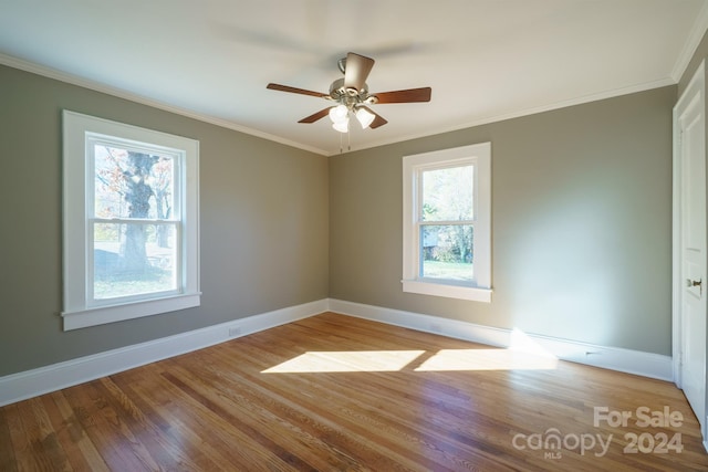 unfurnished room with hardwood / wood-style floors, ceiling fan, and crown molding