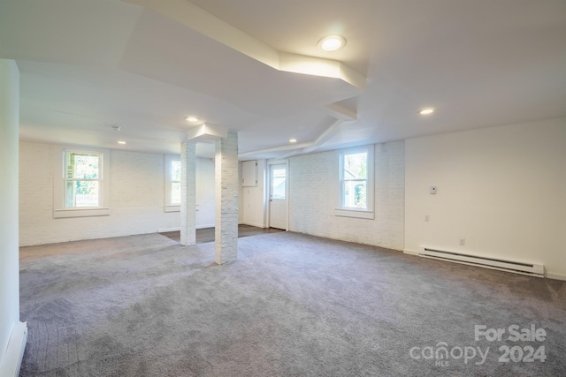 basement with carpet flooring and a baseboard heating unit