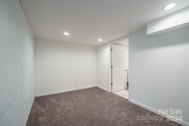 basement featuring light carpet