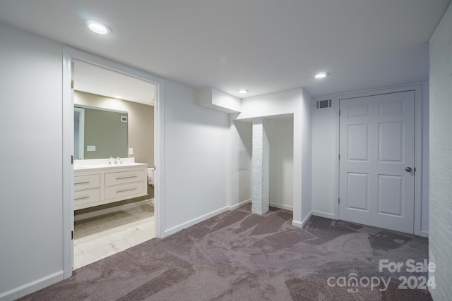 interior space with carpet flooring and sink