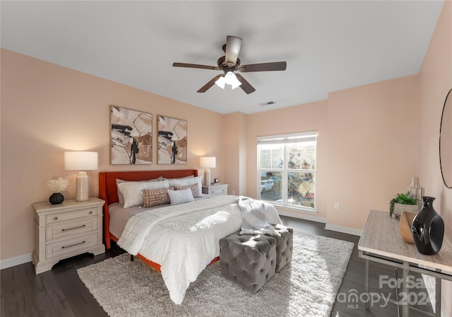 bedroom with ceiling fan and dark wood-type flooring