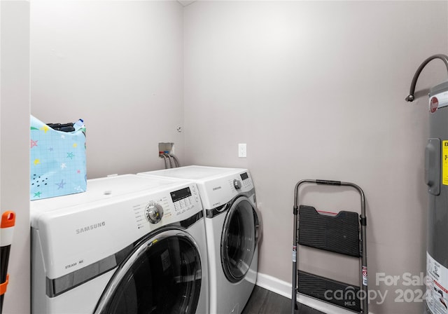 laundry area with washer and clothes dryer and dark wood-type flooring