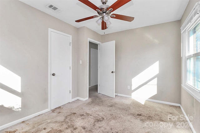 carpeted empty room featuring ceiling fan