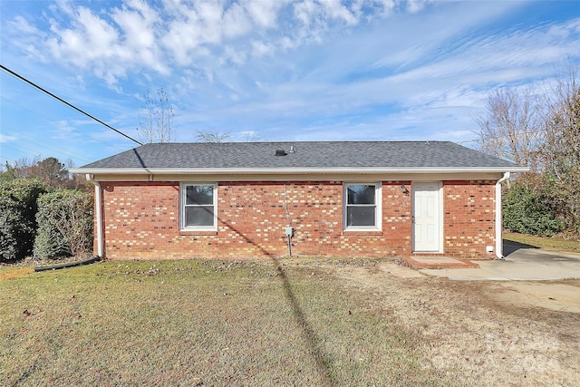 rear view of property with a yard