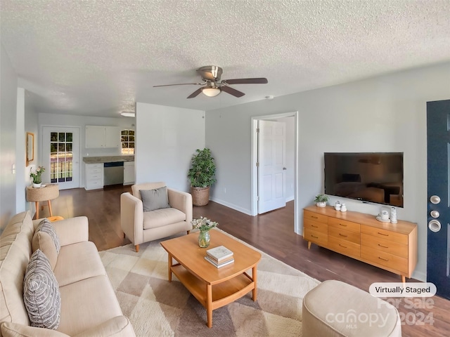 living room with wood-type flooring, a textured ceiling, and ceiling fan