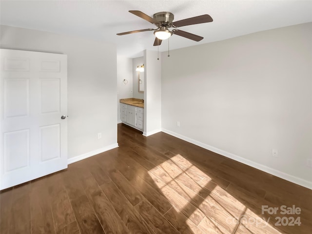 unfurnished living room featuring ceiling fan and dark hardwood / wood-style flooring