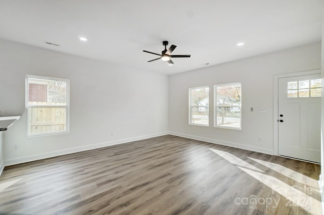 unfurnished living room with plenty of natural light and wood-type flooring