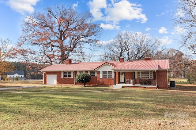 ranch-style house featuring a porch, cooling unit, a garage, and a front lawn