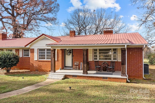 view of front of house with central AC, a front lawn, and covered porch