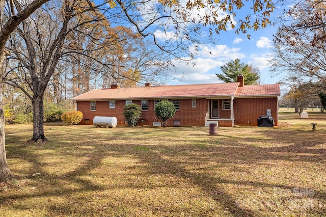 rear view of house with a yard