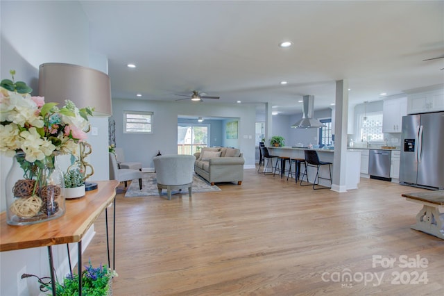 living room featuring light hardwood / wood-style floors and ceiling fan