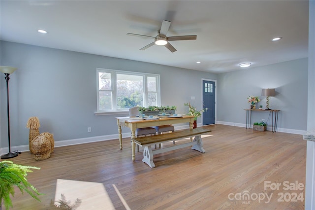 dining area with light wood-type flooring and ceiling fan