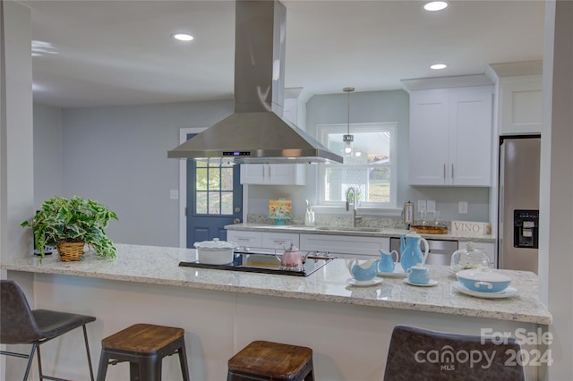 kitchen featuring white cabinetry, sink, stainless steel appliances, light stone counters, and island exhaust hood