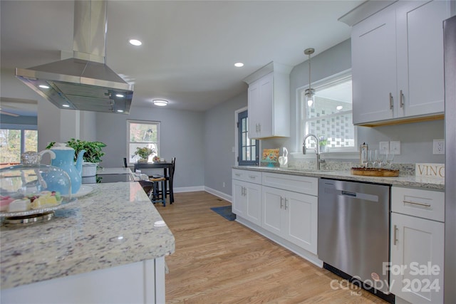 kitchen with island exhaust hood, white cabinetry, stainless steel dishwasher, and a wealth of natural light