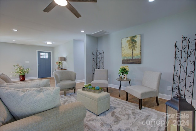 living room with wood-type flooring and ceiling fan