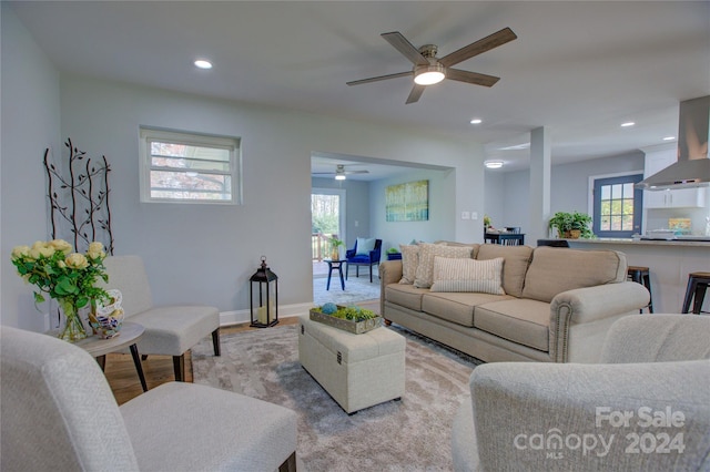 living room featuring ceiling fan and light hardwood / wood-style floors