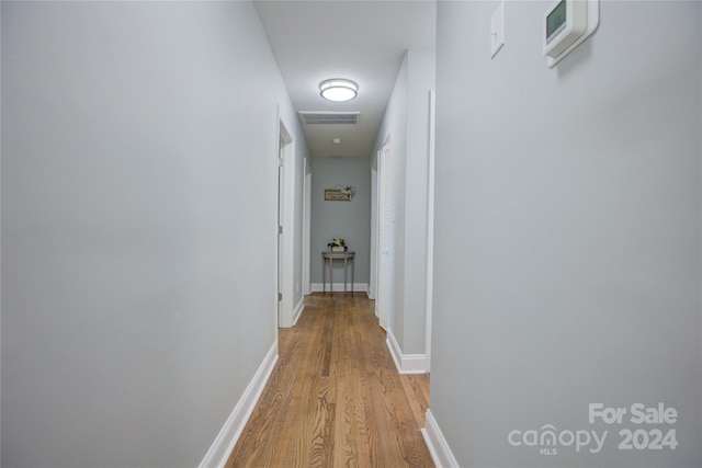 hallway with light hardwood / wood-style flooring