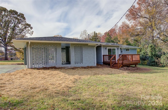 back of house with a lawn and a wooden deck