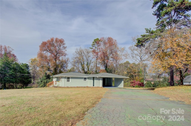 ranch-style home featuring a front yard and a carport