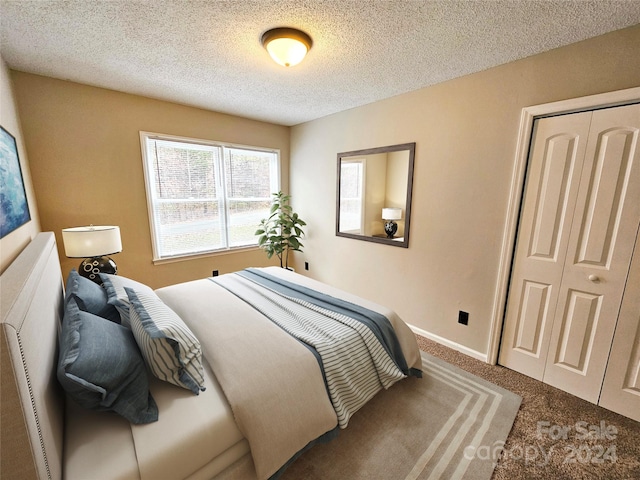 carpeted bedroom with a textured ceiling