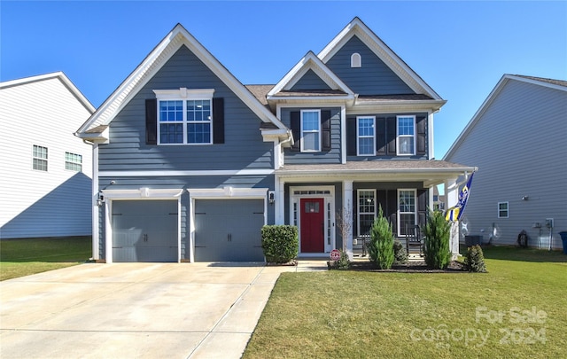 craftsman-style home with a front yard, a garage, and covered porch