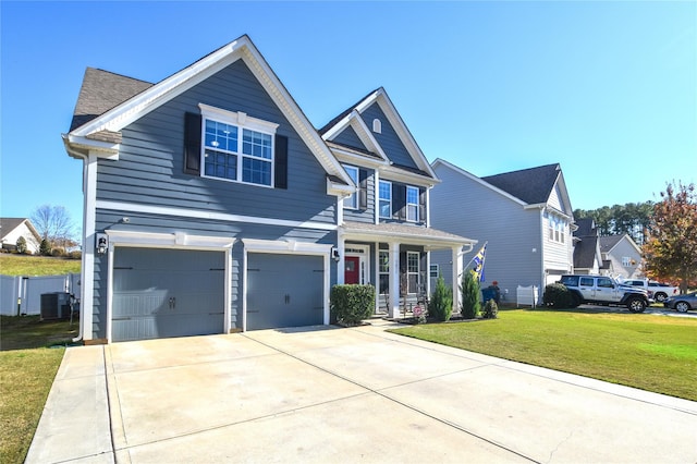 view of front of home featuring central AC, a garage, and a front lawn