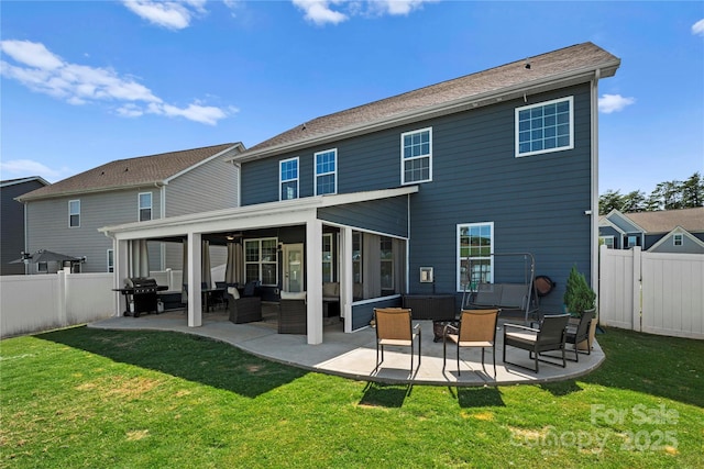 rear view of house featuring an outdoor hangout area, a patio area, and a lawn