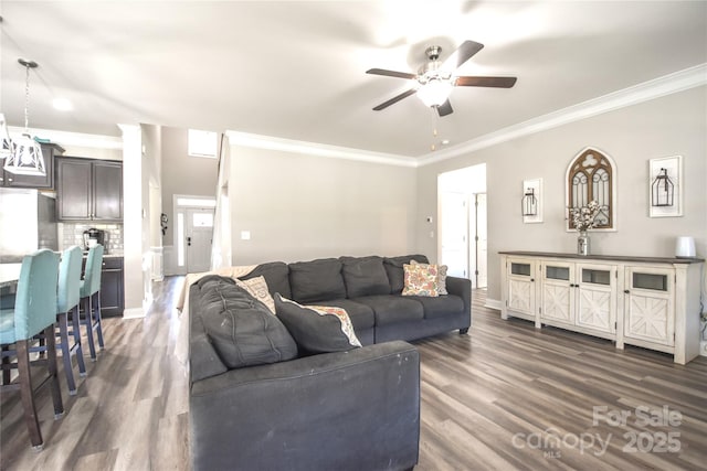 living room featuring ornamental molding, ceiling fan, and dark hardwood / wood-style flooring