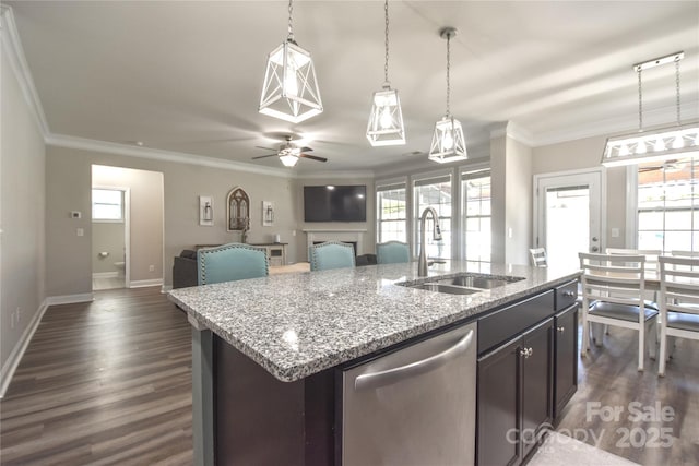 kitchen with decorative light fixtures, sink, ornamental molding, a kitchen island with sink, and stainless steel dishwasher