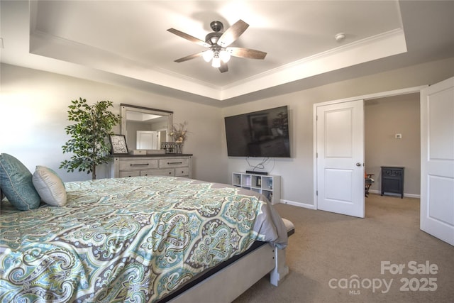 bedroom featuring carpet floors, a raised ceiling, and ceiling fan