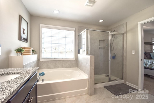 bathroom with vanity, independent shower and bath, and tile patterned flooring