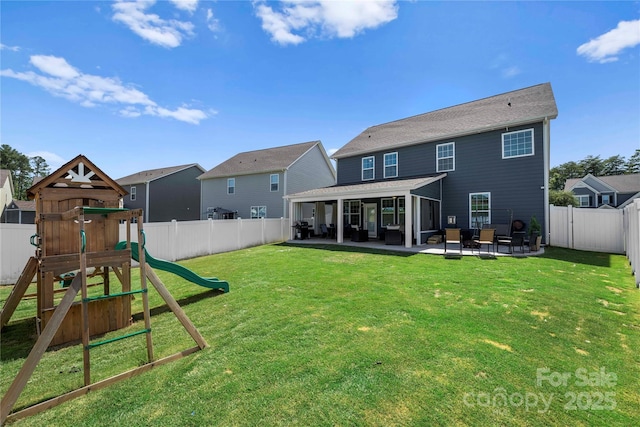 back of house with a patio area, a playground, and a lawn