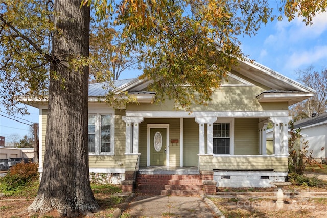 neoclassical home featuring covered porch