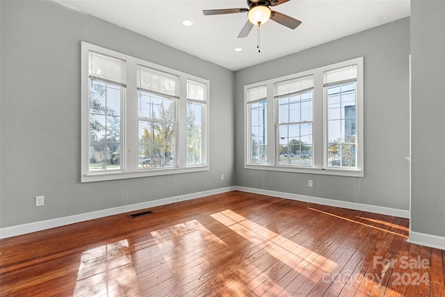 spare room with ceiling fan and wood-type flooring