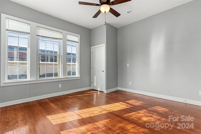 empty room with hardwood / wood-style flooring and ceiling fan