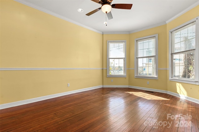 unfurnished room featuring hardwood / wood-style floors, ceiling fan, a healthy amount of sunlight, and crown molding