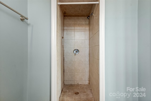 bathroom featuring tile patterned flooring and tiled shower