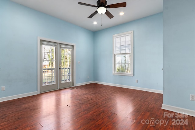 spare room with dark hardwood / wood-style floors and ceiling fan