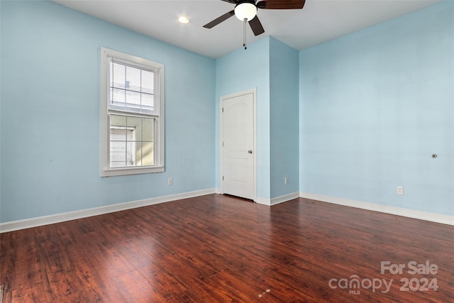 unfurnished room featuring ceiling fan and dark wood-type flooring