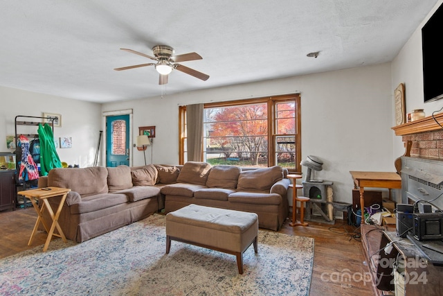 living room featuring hardwood / wood-style floors and ceiling fan