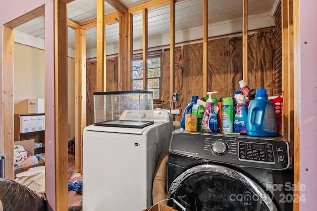 clothes washing area featuring washer and clothes dryer