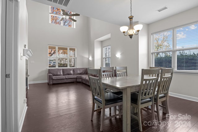 dining room featuring ceiling fan with notable chandelier and dark hardwood / wood-style floors