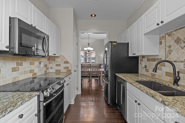 kitchen featuring sink, dark hardwood / wood-style floors, tasteful backsplash, white cabinetry, and stainless steel appliances