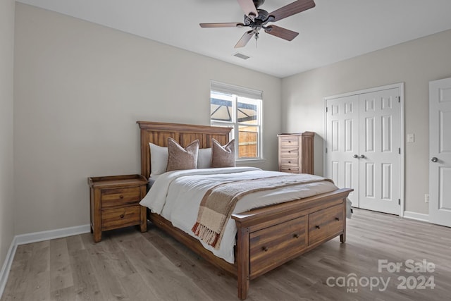 bedroom with wood-type flooring, a closet, and ceiling fan