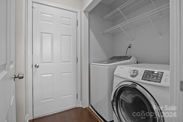 laundry area featuring dark wood-type flooring and washing machine and clothes dryer