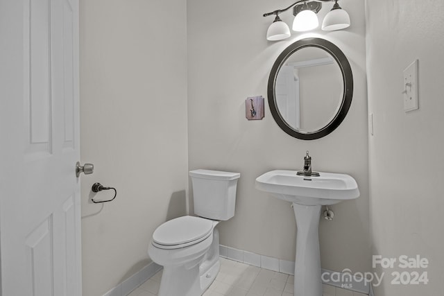 bathroom with tile patterned flooring and toilet