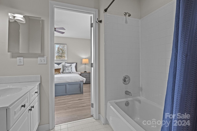 bathroom featuring vanity, hardwood / wood-style flooring, shower / tub combo with curtain, and ceiling fan